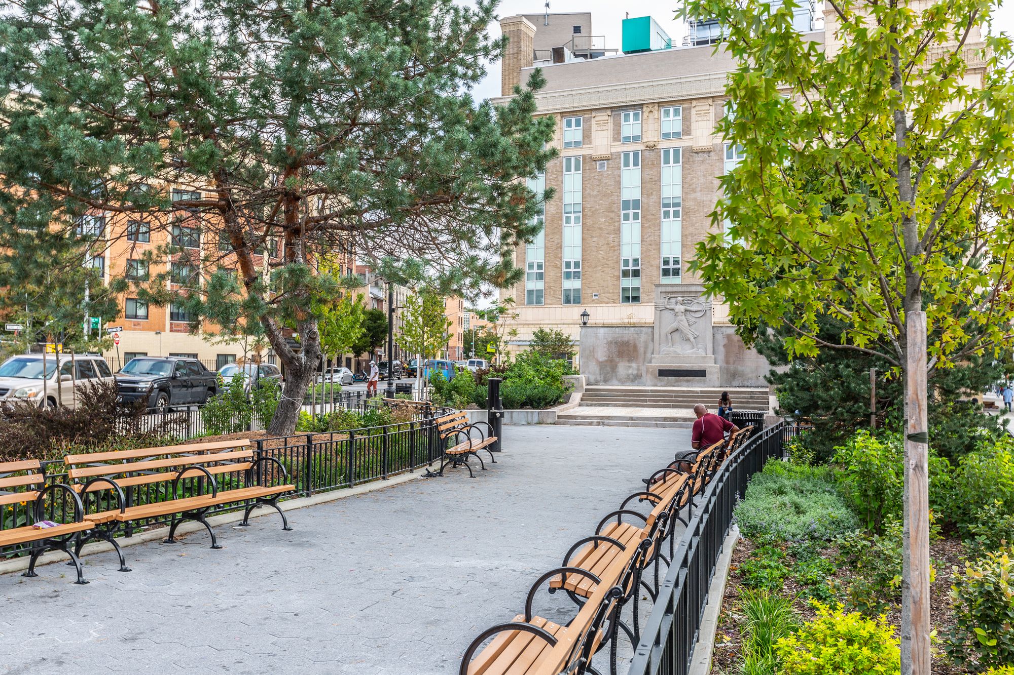 New benches, trees and plantings line the center of the plaza in front of the restored Zion Park War Memorial monument