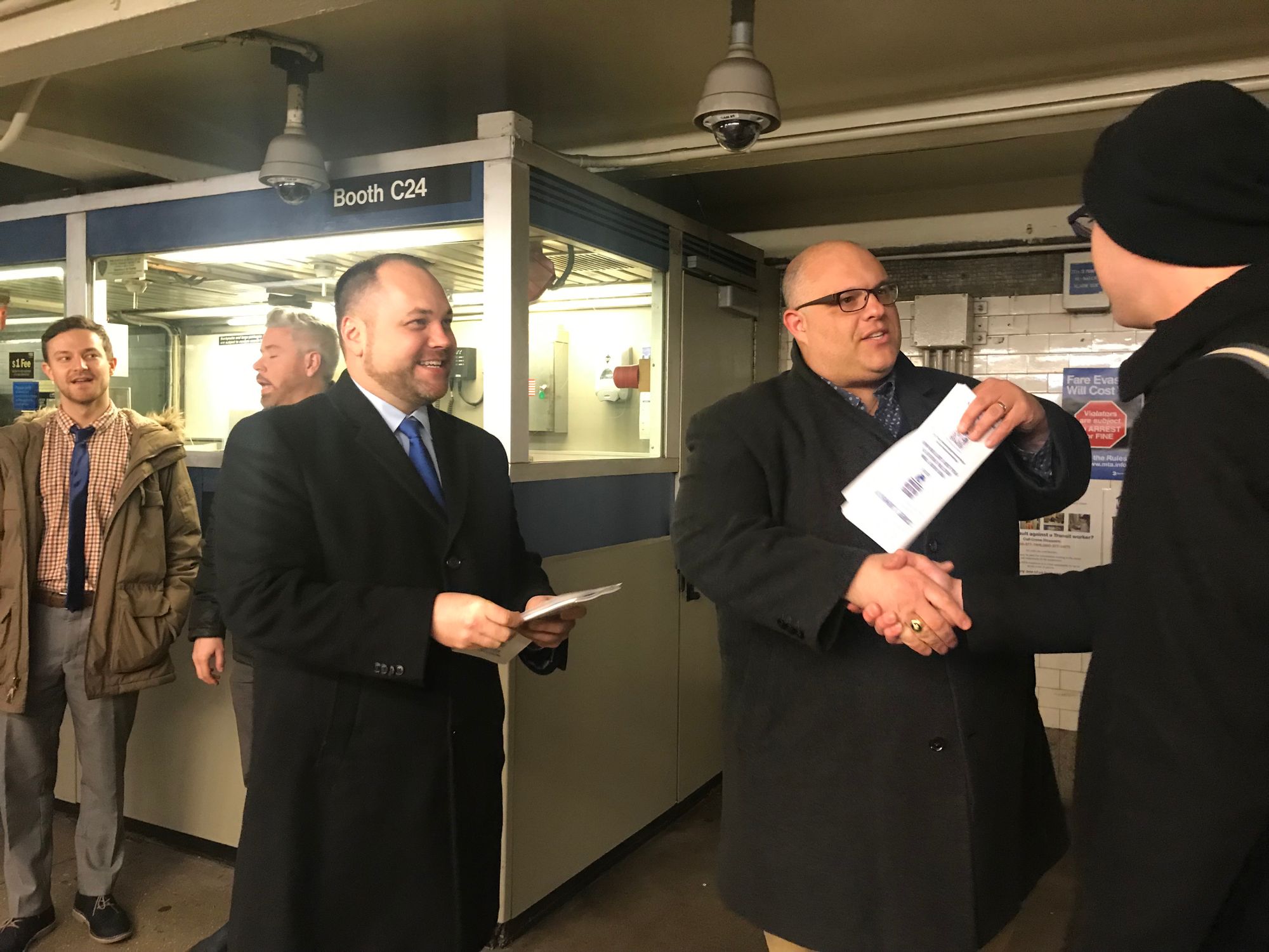 Speaker and Acting Public Advocate Corey Johnson and City Councilman Justin Brannan at the 77th St. R train station passing out subway rider surveys.