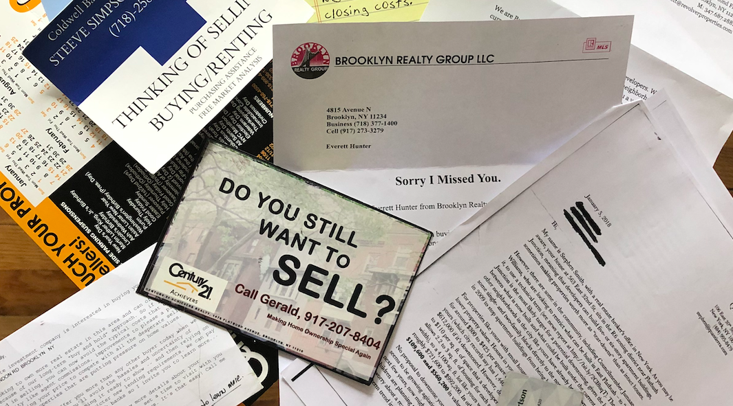 Here are some of the letters and postcards some members throughout Community Board 17 received from developers asking to buy their homes. (Photo credit: Allyson Martinez)