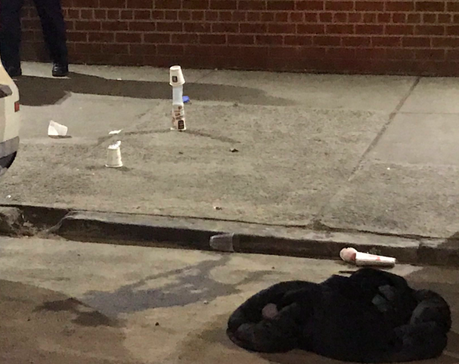 Cops covered shells dispensed at the crime scene of a shooting in front of 650 Washington Avenue. (Photo: Kadia Goba/Bklyner)