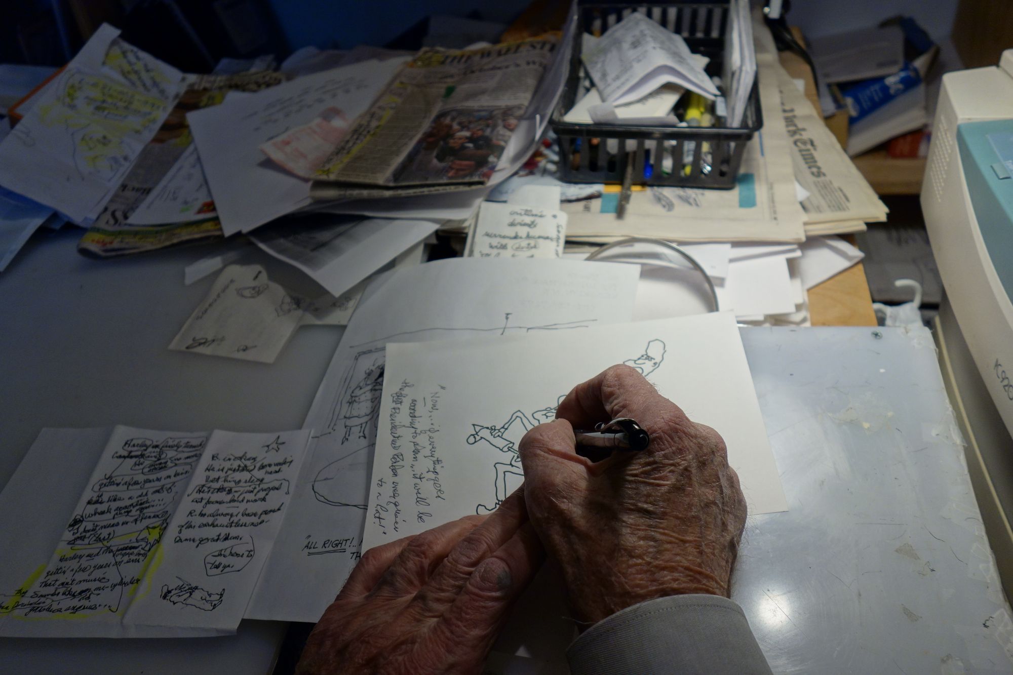George Booth at his draft desk in his Lincoln Place apartment (Photo: Kadia Goba/Bklyner)