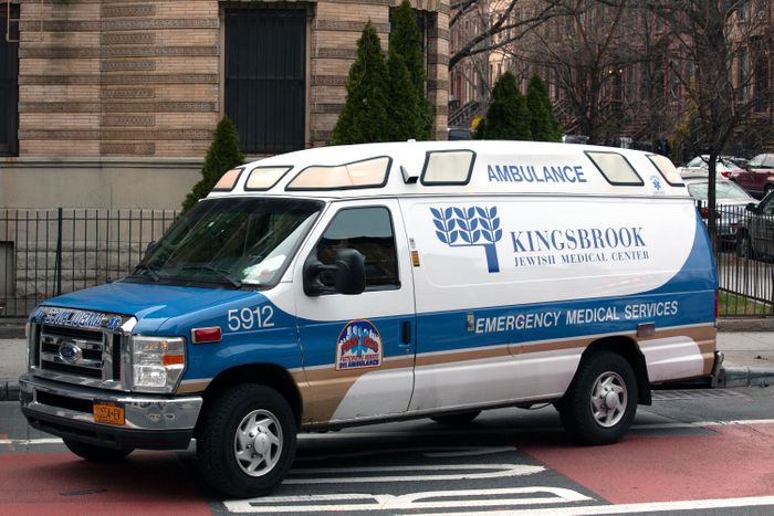 A Kingsbrook ambulance heads toward the hospital after picking up someone from a bus on Nostrand Avenue, March 18, 2020. Photo: Ben Fractenberg/THE CITY