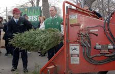 Mayor Bloomberg and Comissioner Benepe feeing a tree into a chipper