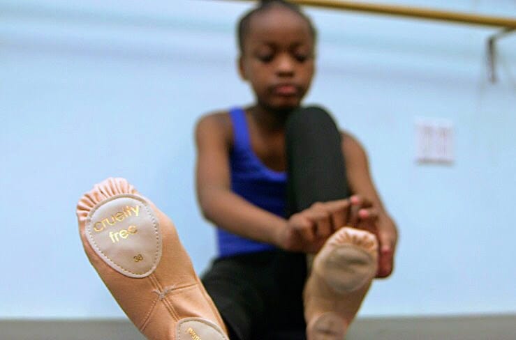 Vegan Woman Grips the Soles of Dancers