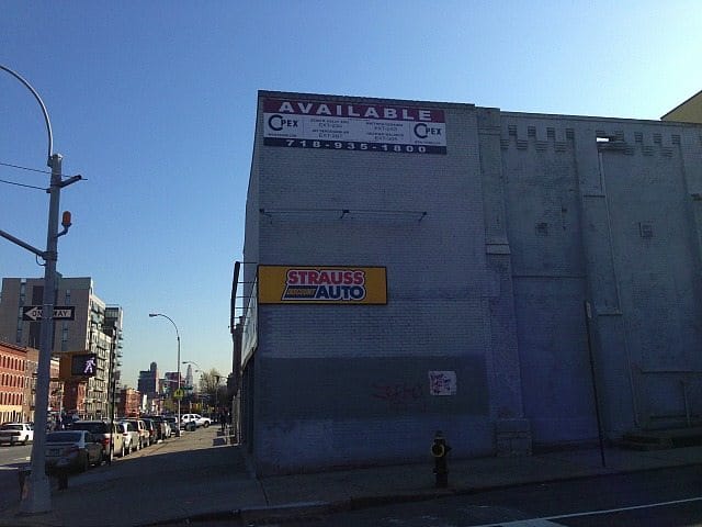 Real Estate Sign Appears On Old Strauss Auto Building