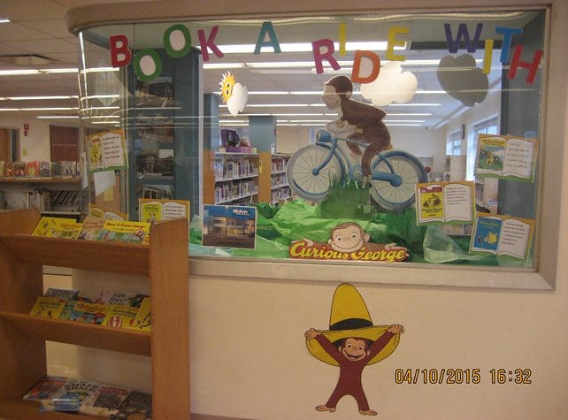 Pose For Photos With A Child-Size Curious George At Kings Highway Library