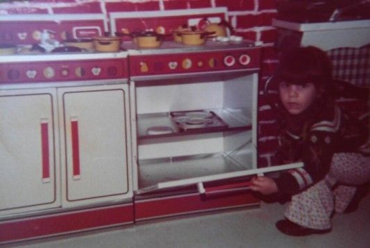 Rosie in Her Play Kitchen as a Child