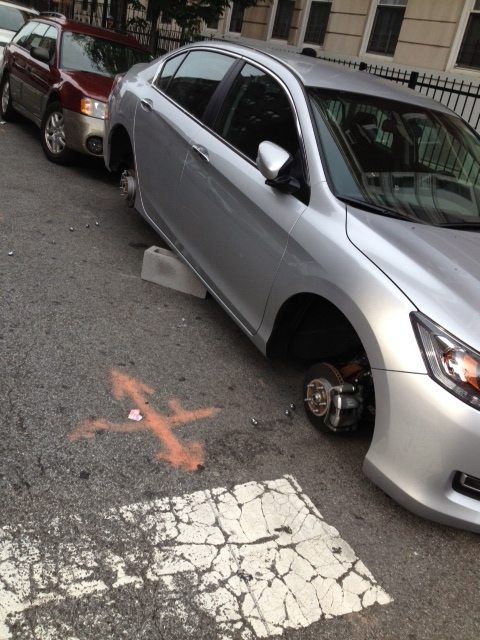 car with stolen wheels on beverley and e 21