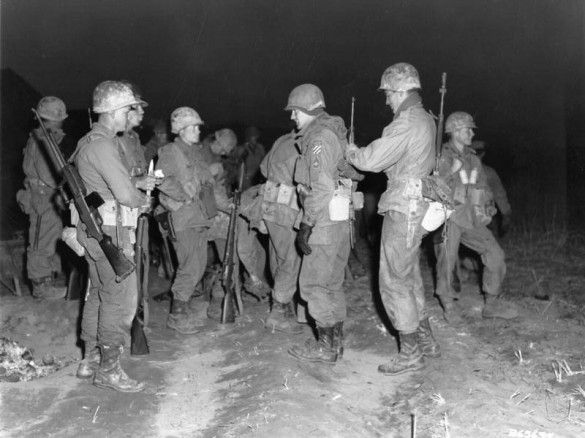 Men of the 3rd Ranger Company, 3rd Infantry Division, adjust their gear before undertaking a dawn patrol across the Imjin River, Korea. Source: KoreanWar60.com