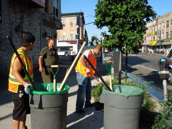 John Imbriale and Sanitation staff cleaning tree pits at Kensington Plaza