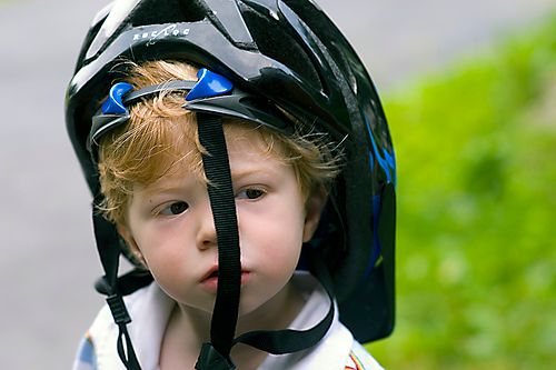 kid with bike helmet by Ben McLeod