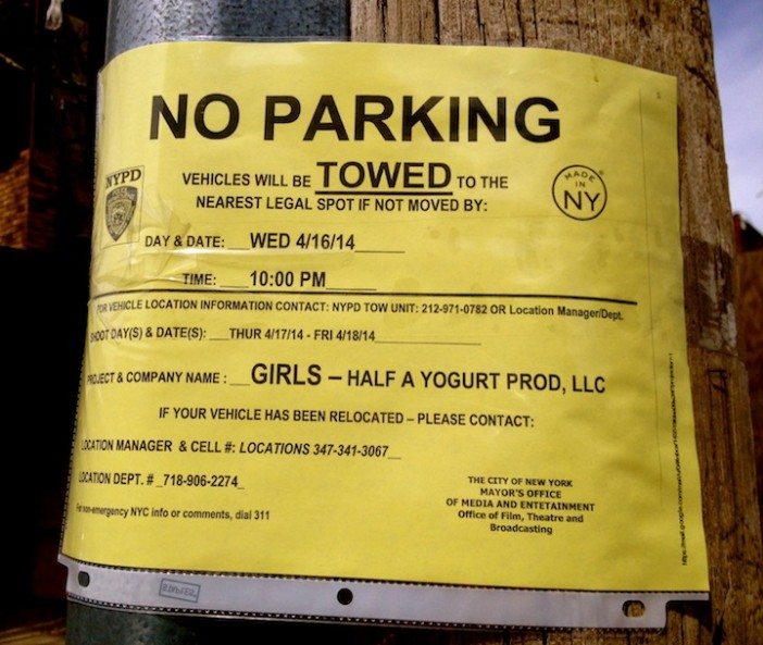 girls filming sign