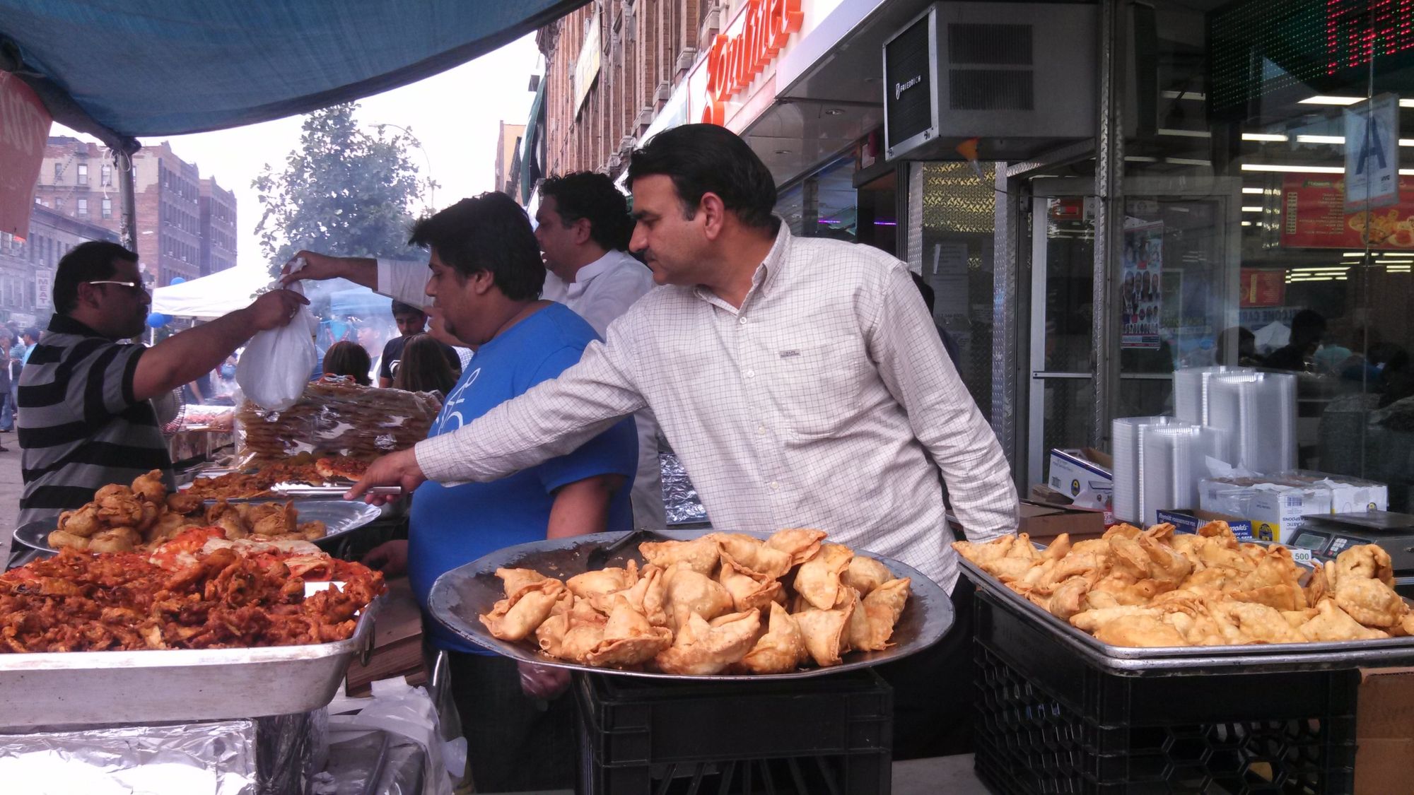 A food vendor tends to his stall during this year's Mela, which drew thousands of people to Coney Island Avenue in August to celebrate Pakistan's independence.