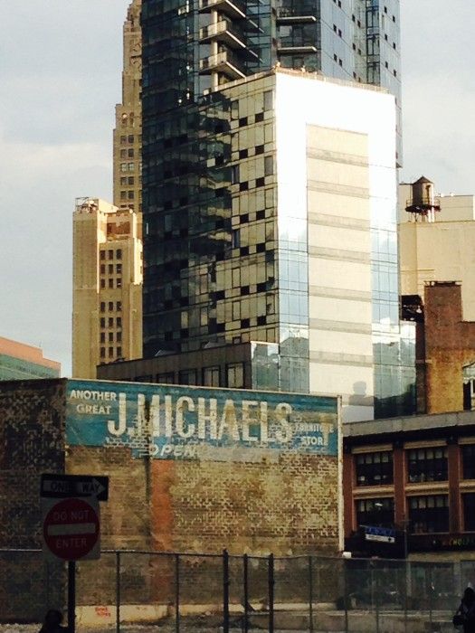 old sign and new building by John Atkins