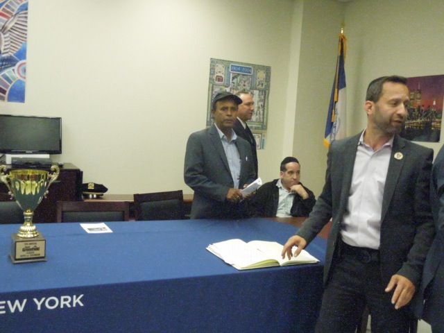 The Golden Trophy with 66 Pct Community Council officers, D.I. Deddo, in profile center rear; Mohammad J. Alam, left; Marc Katz, President, right