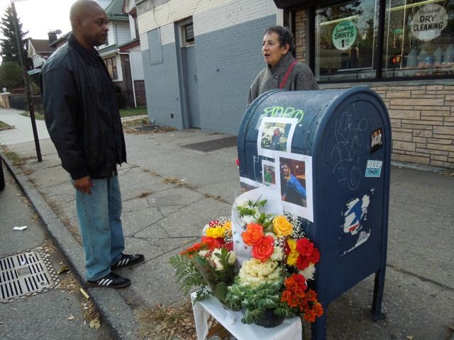 Not long before the funeral for Naiem Uddin, neighbors stand by a memorial for the boy at Caton Avenue and E. 7th Street.