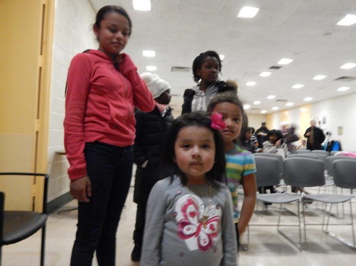 70th Precinct Community Counicl holiday kids waiting for presents