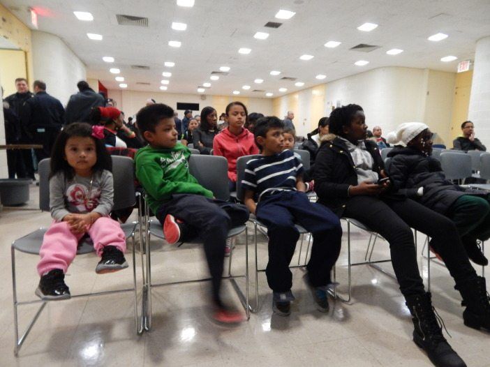 Neighborhood children wait patiently for presents given through Toys for Tots.