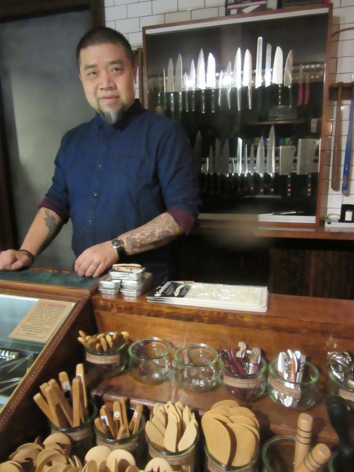 Knife and Spork owner Symon Chow shows off some of the shop's inventory. 