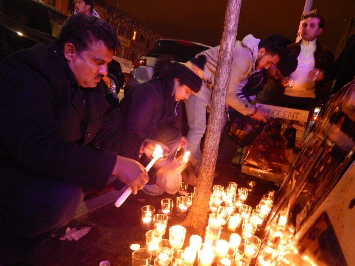 Peshawar vigil people lighting candles 1