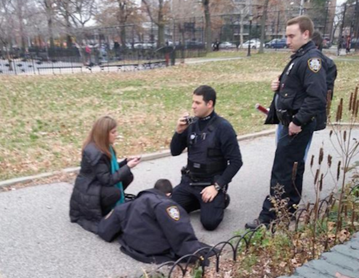 Officer Passarella [kneeling] and Officer Alberti [standing] help boy find his mother. Photo by Officer Thomas Hobkins