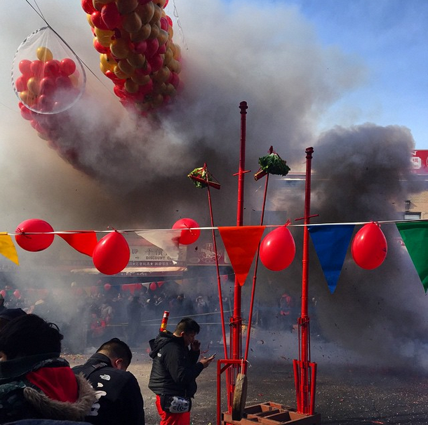 Firecrackers go off during the festivities. Photo by lizlig.