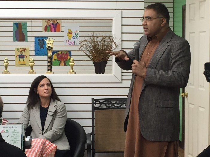 Neighbor Shahid Khan, of BRICK, addresses the crowd as Community Board 14 District Manager Shawn Campbell looks on. Photo courtesy Maria Newsom