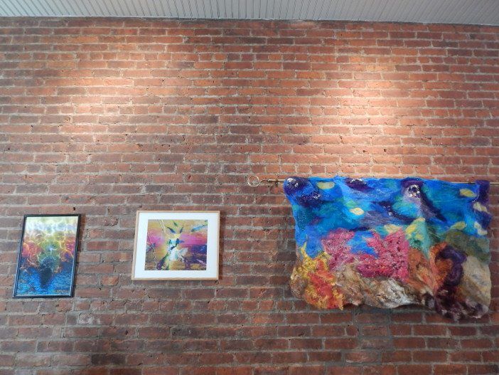 Two of Elaine Mamary's photographs, which she creates by combining several images together, and Madeline Sorel's Nuno felt creation are now on exhibit.