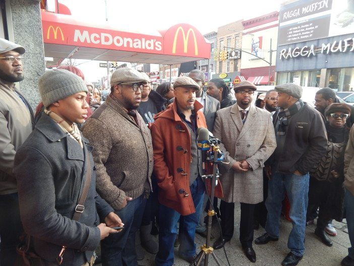 Kevin Foy, of the National Action Network, and other area leaders gathered outside the McDonald's at 943 Flatbush Avenue yesterday.