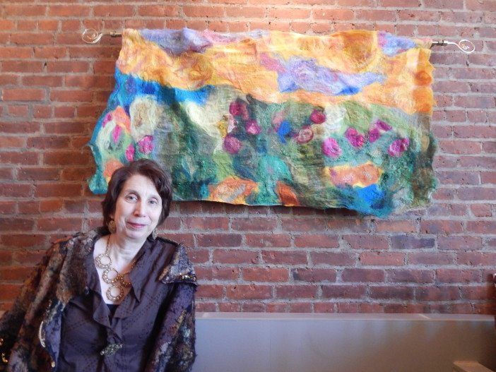 Madeline Sorel stands by one of her Nuno felt pieces, which is created using a fabric felting technique started by Polly Stirling, an Australian artist, in the 1990s.