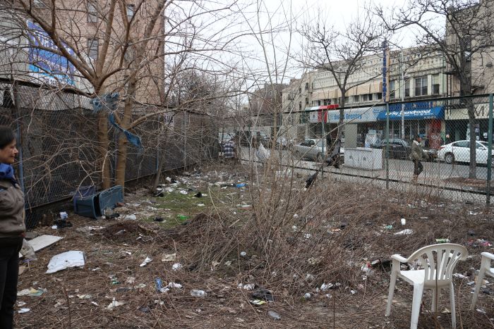 Before neighbors cleaned the space, it was filled with trash and debris. Photo via Q Gardens