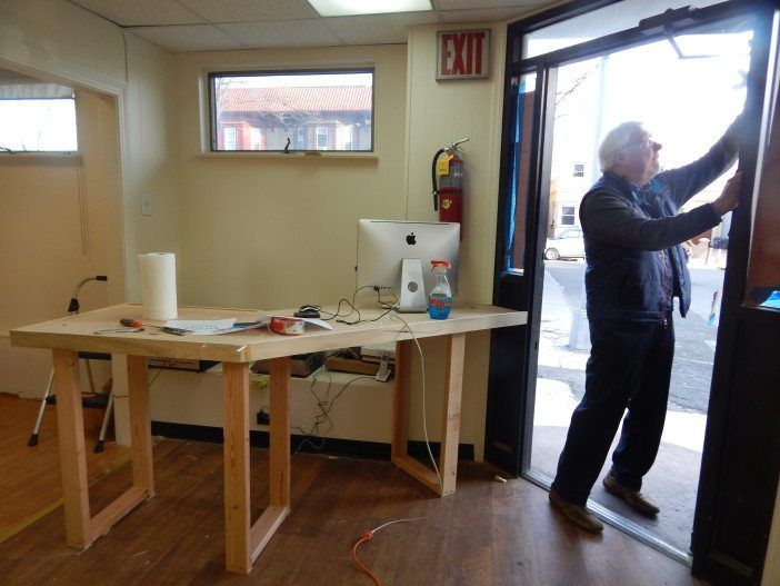 Jack O'Connell hangs informational signs on the co-ops door.