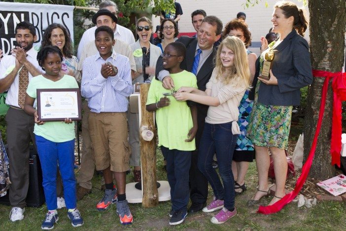 Students celebrate winning the Golden Apple and Golden Shovel Awards for the school's sustainability work. Photo courtesy of BUGS.