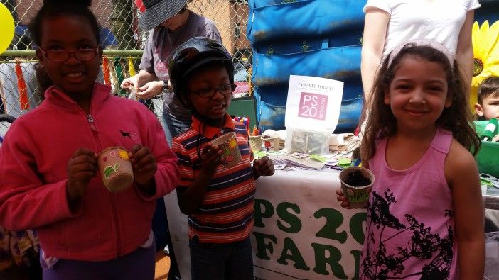 Jaren, nine, Harrison, five, and Nadia, five, with their decorated planters at the Earth Day Expo.