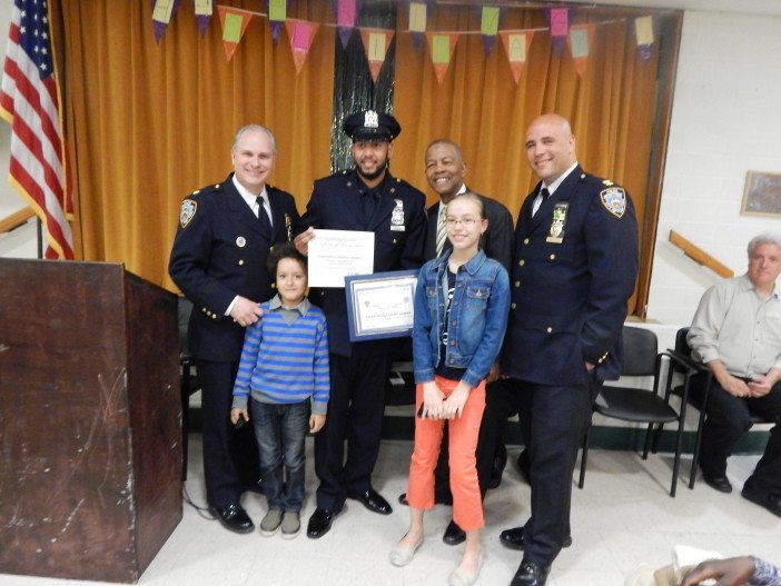 Officer Dalmin Vasquez, center, was honored as the 70th Precinct's Cop of the Month at yesterday's meeting. He is joined by his children, Deputy Inspector Richard DiBlasio, far left; Community Council President Ed Powell, second from right, and Executive Officer Anthony Sanseverino, far right.