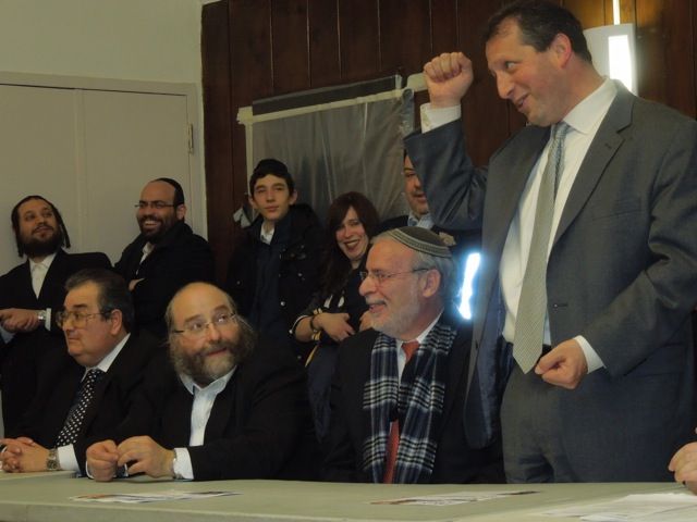 Councilman Brad Lander salutes Deddo as state Assemblyman Dov Hikind, on left in plaid scarf, and Jacob Daskal, head turned to Lander, of the Boro Park Shomrim Patrol, look on.