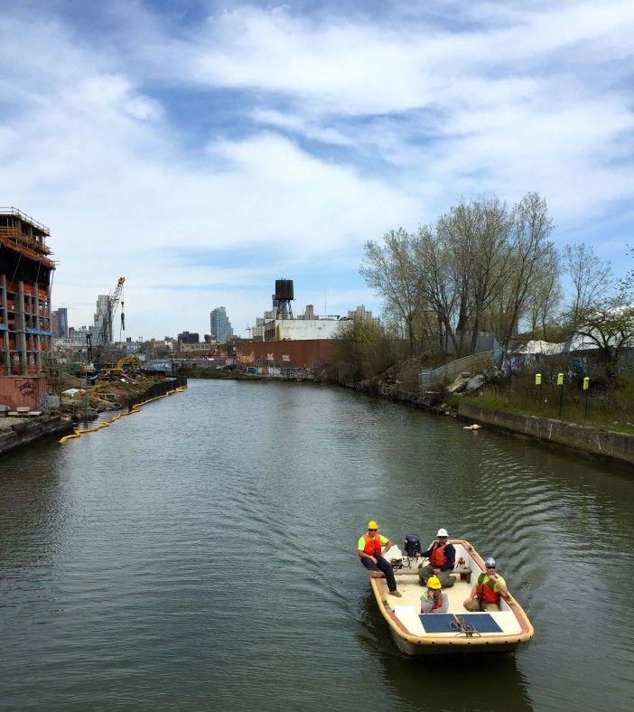 A boat of workers passes on the canal, announcing Swain has not jumped in yet.