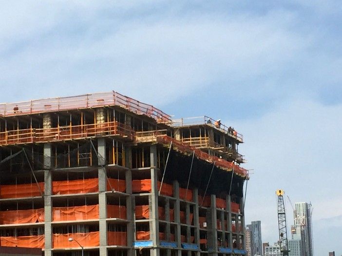 Workers at the Lightstone construction project paused to watch the swimmer.