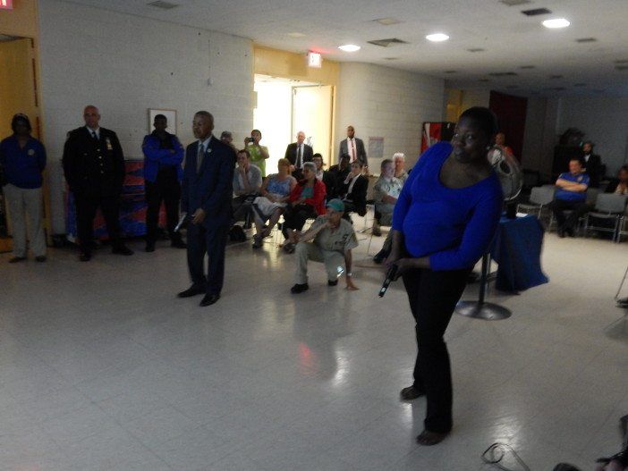 70th Precinct Community Council President Ed Powell, left, and Vice President Tamika Williamson try out the firearm simulator.