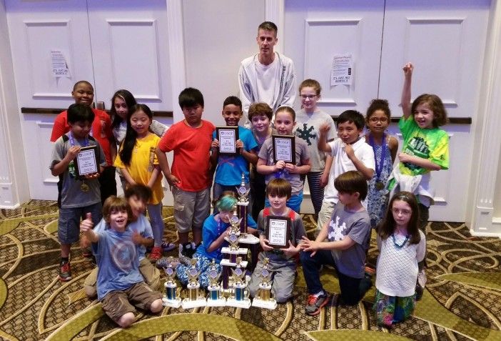 The PS 139 Chess Ninjas and their coach, Ian West, celebrate their incredible performance at the Nationals last weekend. Photo courtesy PS 139 Chess Ninjas