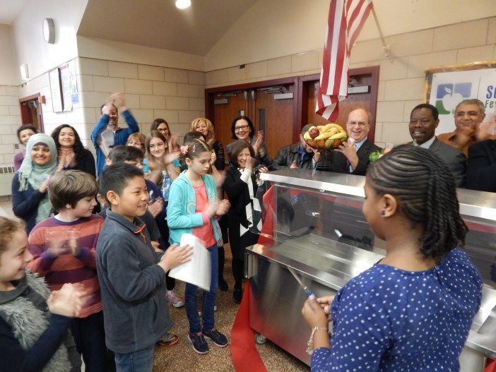 Students cut the ribbon on the new salad bar.