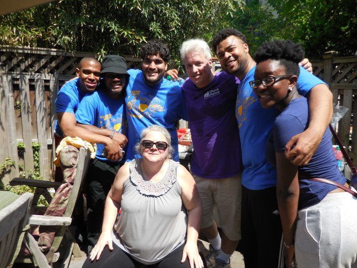 Volunteers at Saturday's neighborhood clean-up, including Flatbush Development Corporation Executive Director Robin Redmond, sitting center; Anthony Finkel, of the FDC, second from right; and community leader Nathan Thompson, third from right.