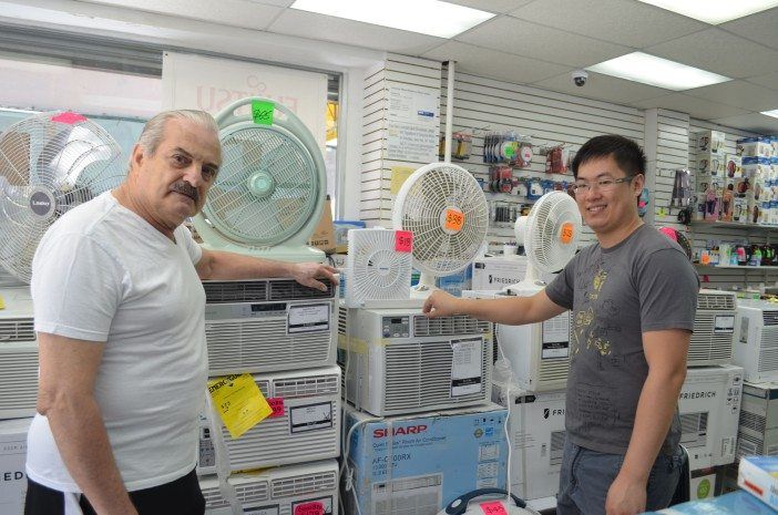 A man looks at air conditioners at a local appliance store. 