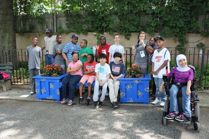 Kids from PS53 with the bench they built for the Butterfly Garden