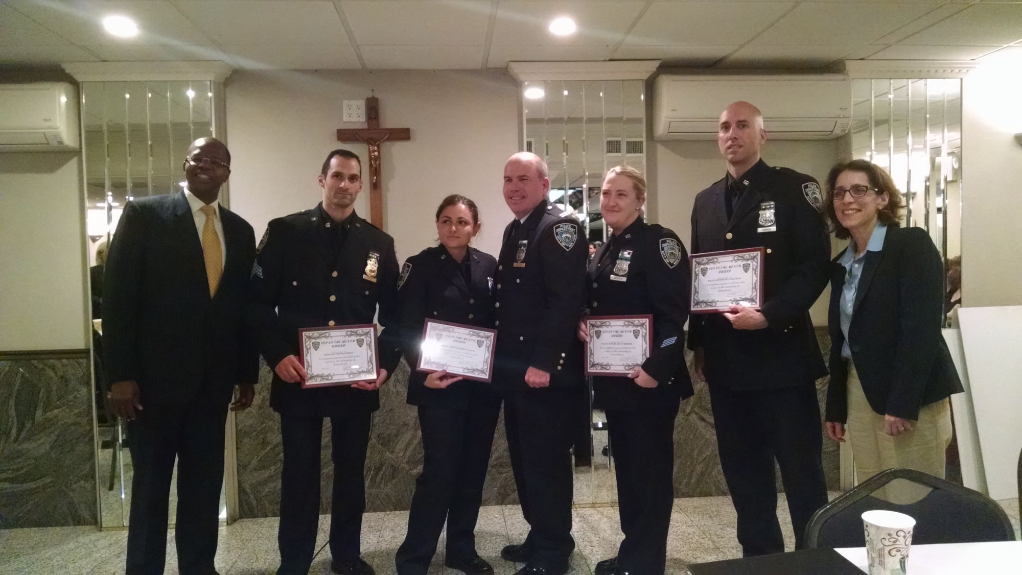 [L-R] Sgt. Thomas Parco, Officer Kelly Merrick, Officer Romina Cekani, and Officer Dylan Kangas, of the 62nd Precinct’s Domestic Violence Unit are honored by DA Ken Thompson and Captain William Taylor. (Photo by Rachel Silberstein/Bensonhurst Bean)