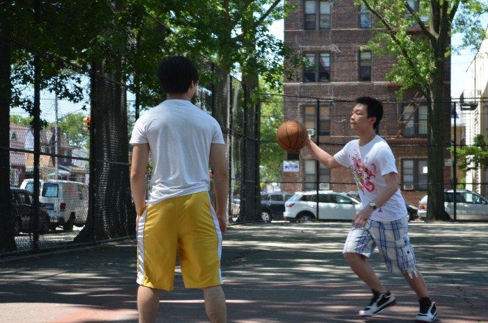 High schoolers play basketball.