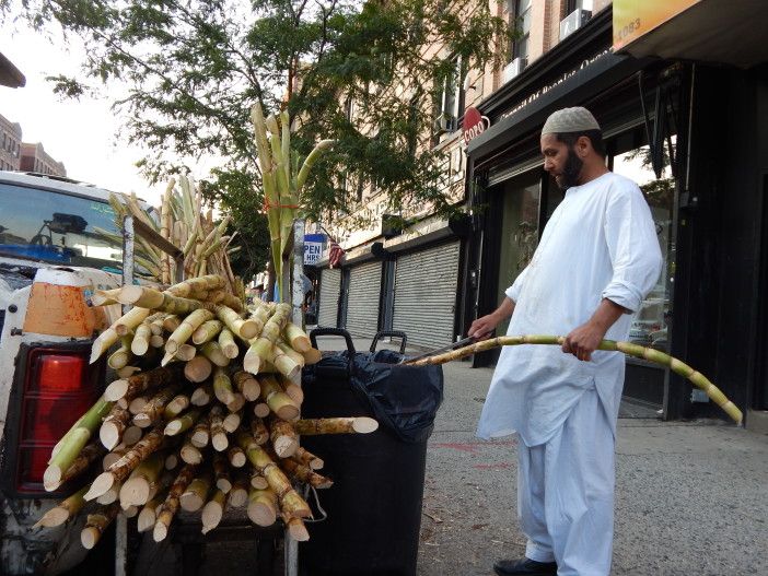 A man makes drinks from bamboo stalks.