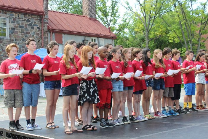 Students from Piper Theater Company singing the National Anthem