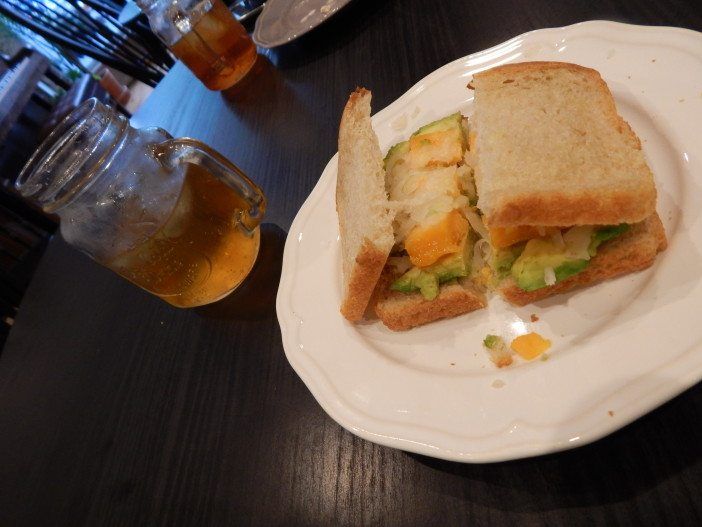 The avocado, cheese and sauerkraut sandwich and iced tea.