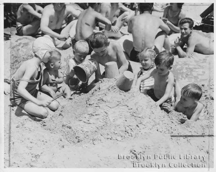 kids building sand castles on coney island in 1946